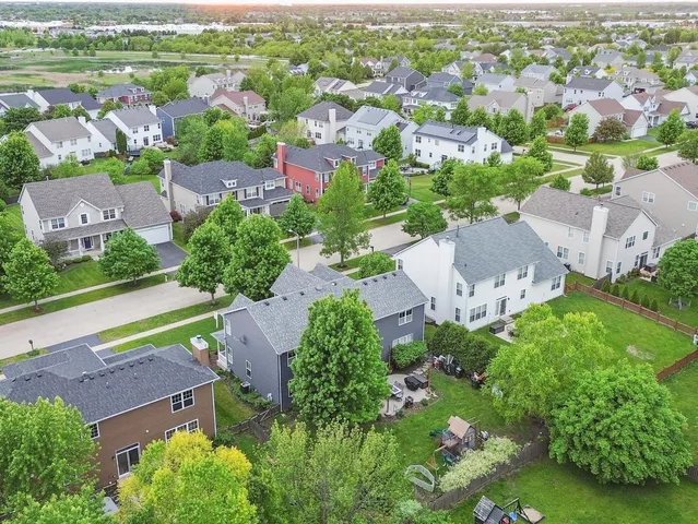 an aerial view of residential houses with outdoor space and street view