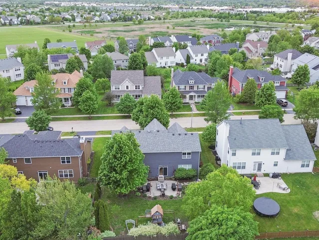 an aerial view of residential houses with outdoor space and river view