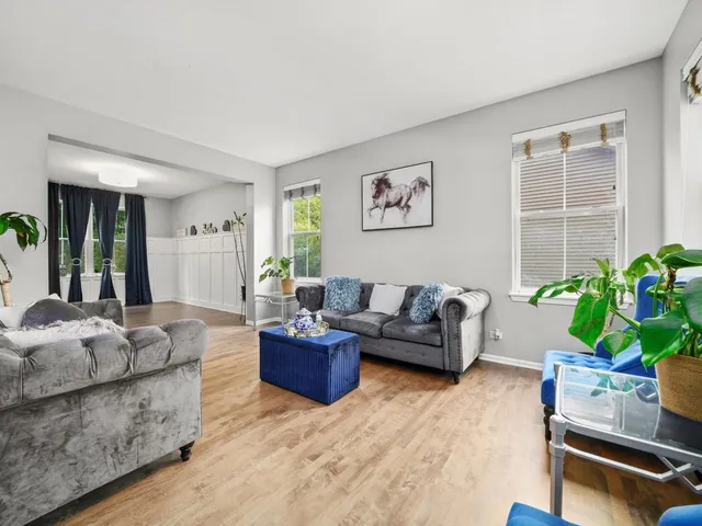 a living room with furniture and a potted plant