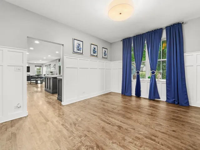 a view of a living room hardwood floor and a kitchen