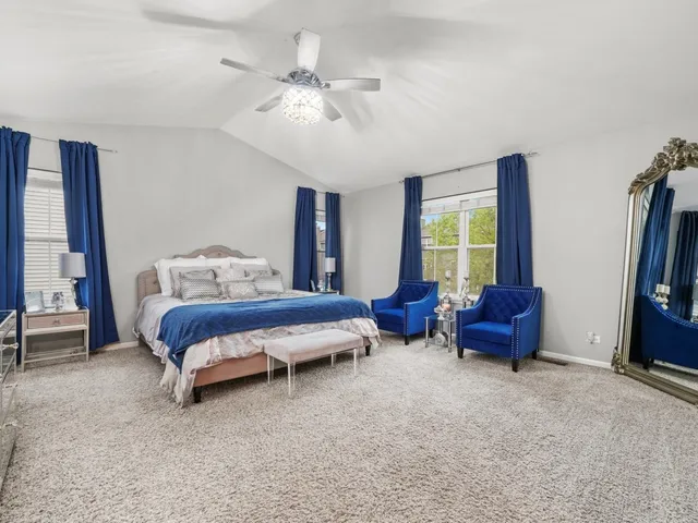 a bedroom with furniture and a large window