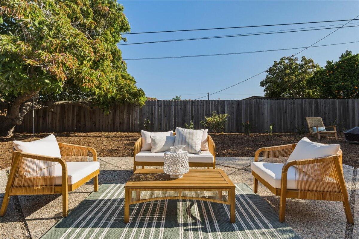 6231 Aberdeen Avenue Goleta, CA 93117 - Photo 3 of 15 a view of patio with table and chairs with wooden floor and fence and trees