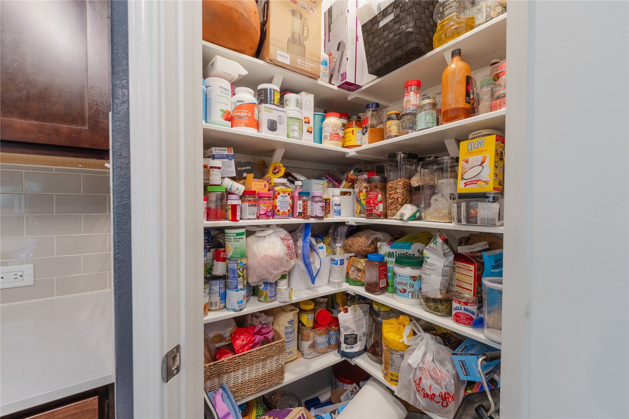 425 Perfect World Loop Jarrell, TX 76537 - Photo 24 of 29 Spacious corner pantry featuring multiple levels of shelving