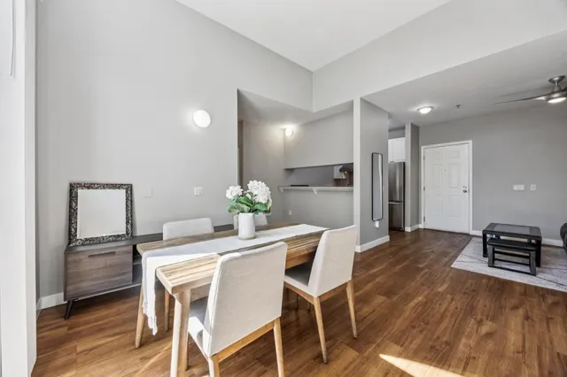 a dining room with furniture and wooden floor