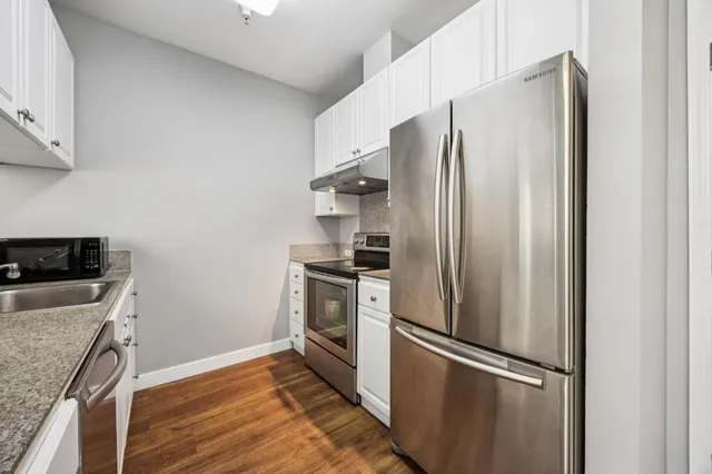 a kitchen with stainless steel appliances granite countertop a refrigerator and a sink