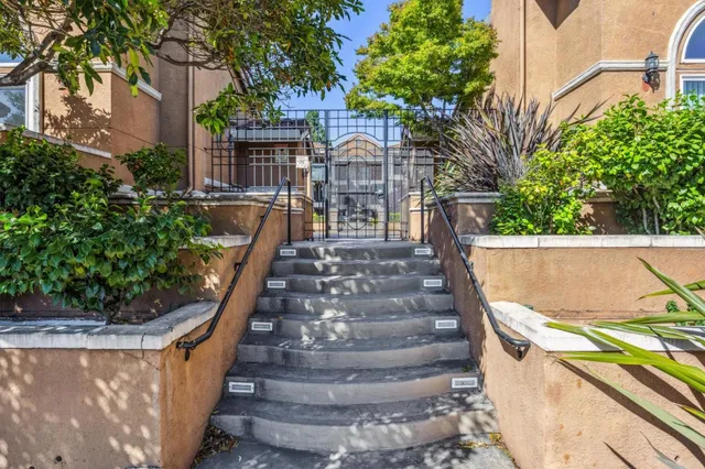 a view of statue in a yard with potted plants