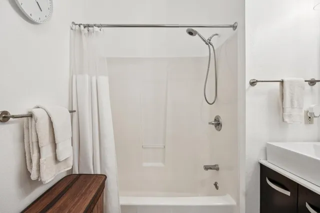 a bathroom with a shower and a tub