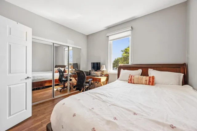 a bedroom with bed and chair