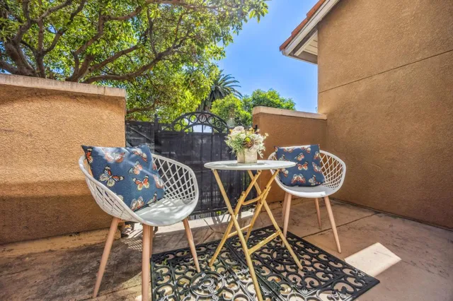 a view of a dining room with a table and chairs