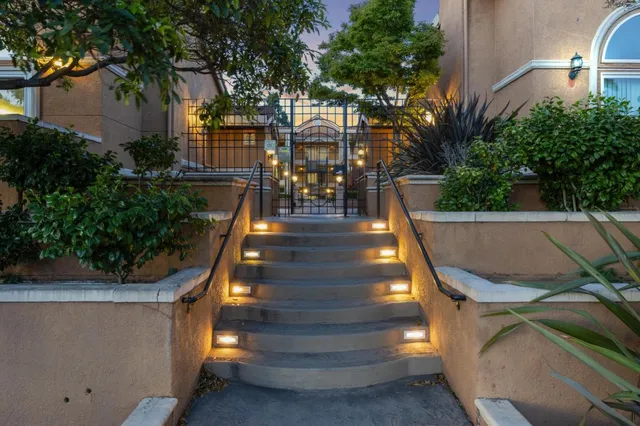 a view of a house with backyard swimming pool and sitting area