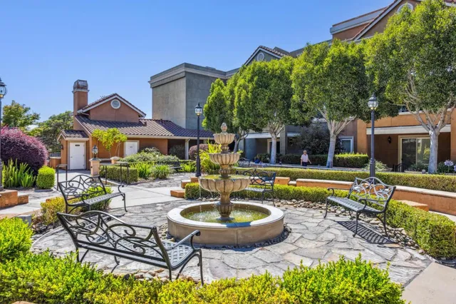 a view of a house with swimming pool and sitting area