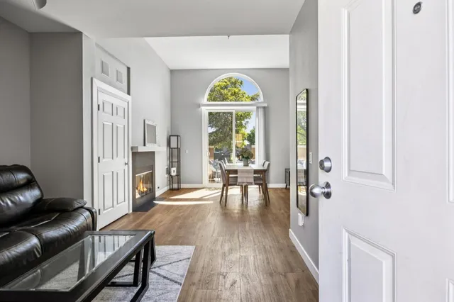 a view of a livingroom with furniture wooden floor and a window