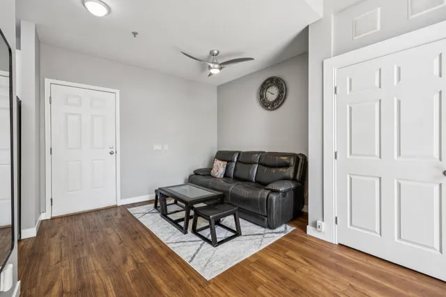 a living room with furniture and a wooden floor