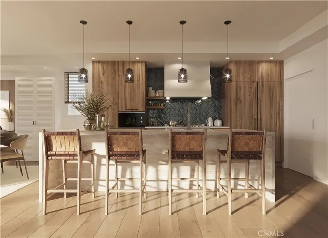 a kitchen with stainless steel appliances kitchen island granite countertop a table and chairs