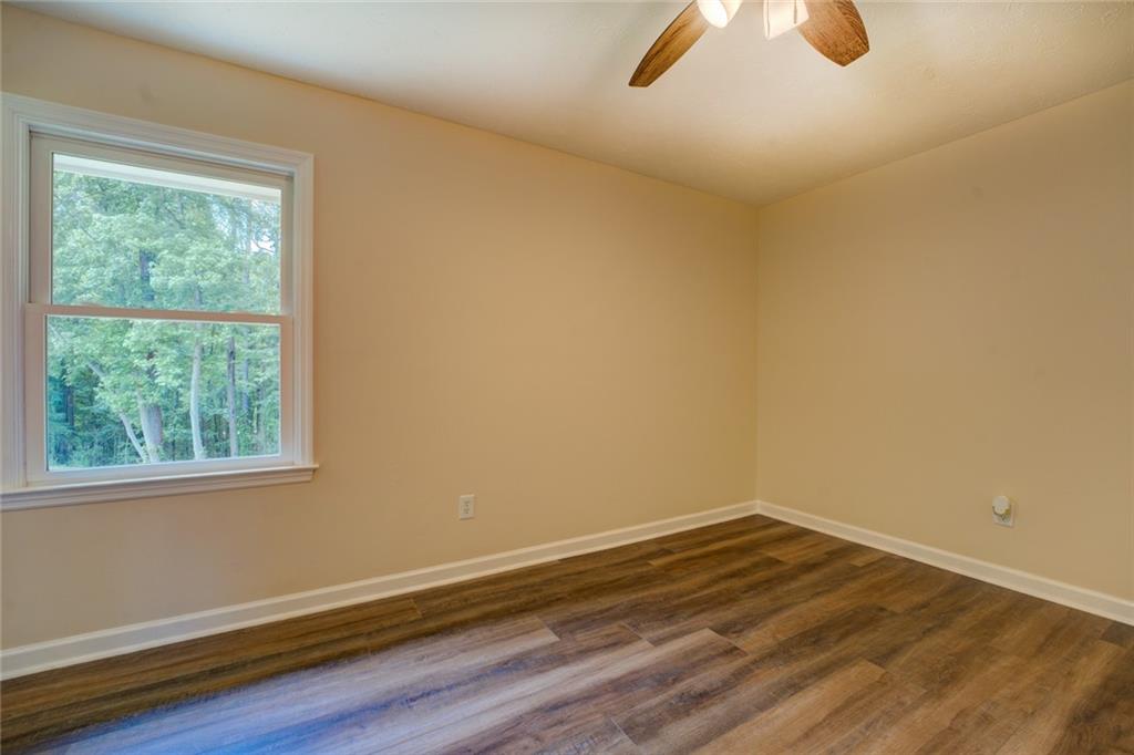 170 Hidden Pines Drive Covington, GA 30016 - Photo 12 of 22 a room with a wooden floor and windows