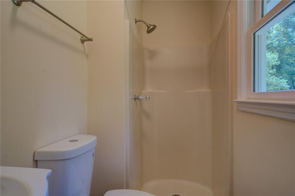 170 Hidden Pines Drive Covington, GA 30016 - Photo 13 of 22 a bathroom with a toilet and a shower