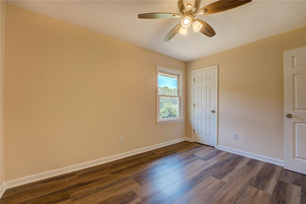 170 Hidden Pines Drive Covington, GA 30016 - Photo 16 of 22 wooden floor in an empty room with a window