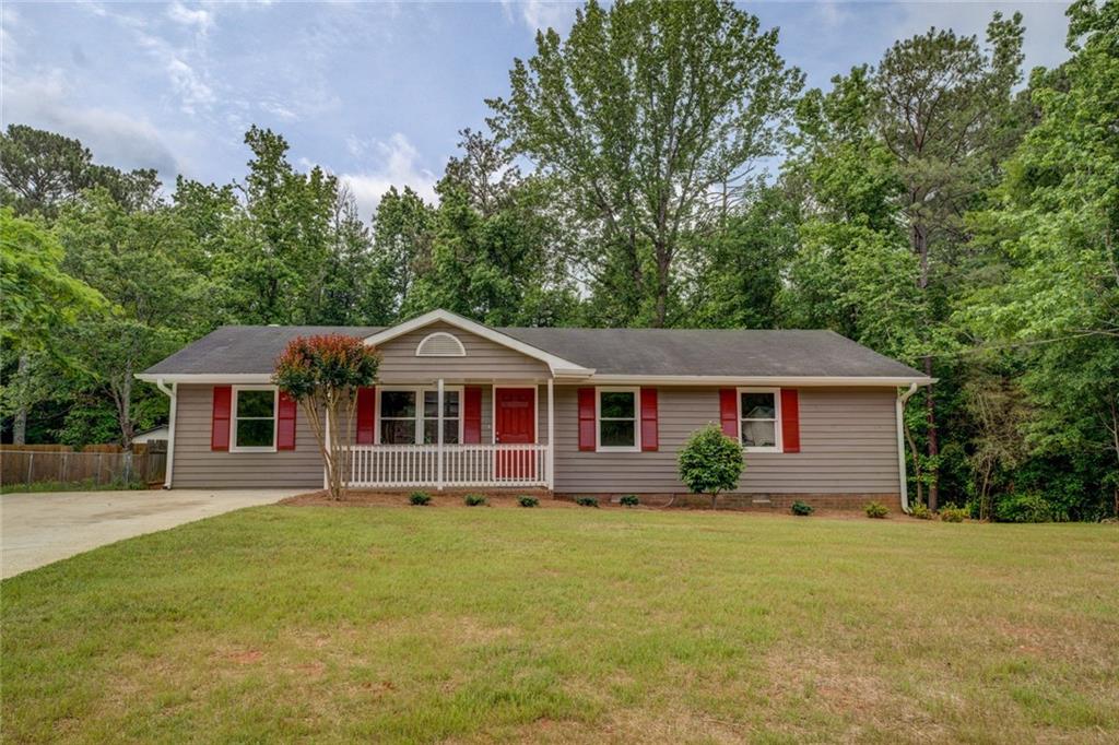 170 Hidden Pines Drive Covington, GA 30016 - Photo 19 of 22 a front view of house with yard and trees in the background