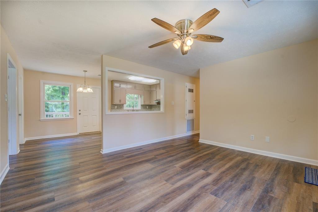 170 Hidden Pines Drive Covington, GA 30016 - Photo 5 of 22 an empty room with wooden floor and windows