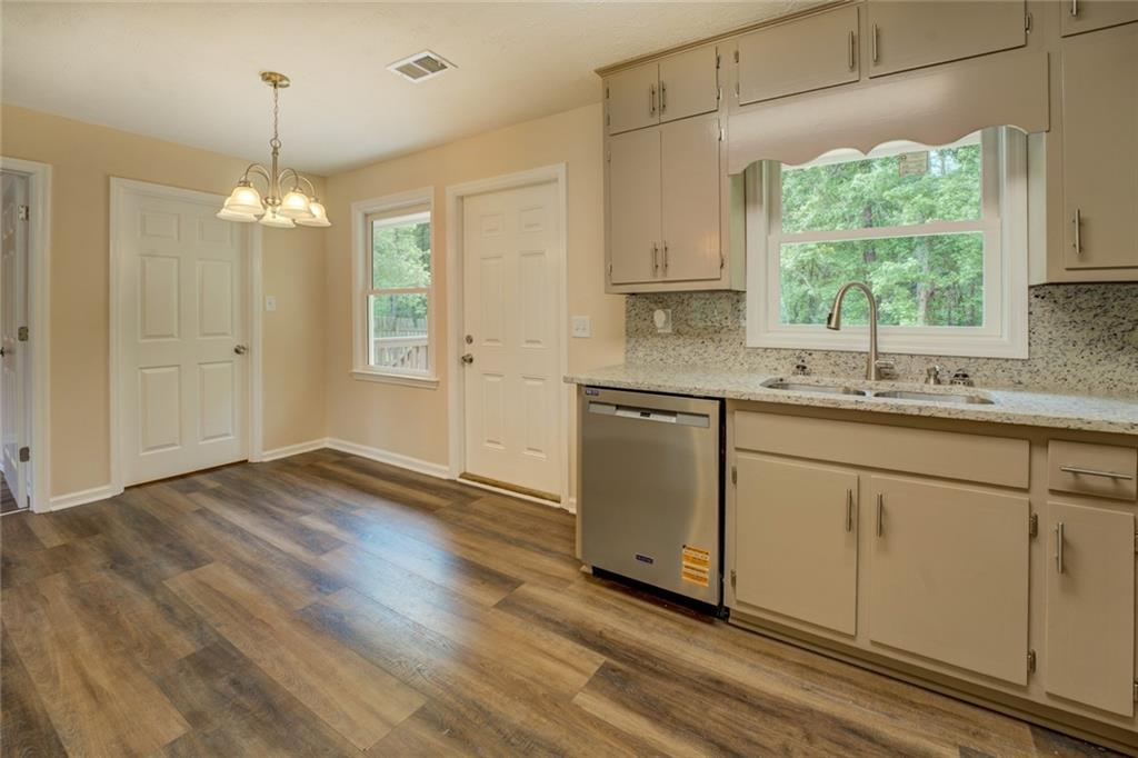 170 Hidden Pines Drive Covington, GA 30016 - Photo 8 of 22 a kitchen with a sink window and cabinets