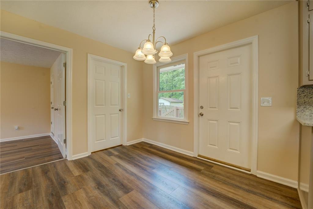 170 Hidden Pines Drive Covington, GA 30016 - Photo 9 of 22 a view of an empty room with window and wooden floor