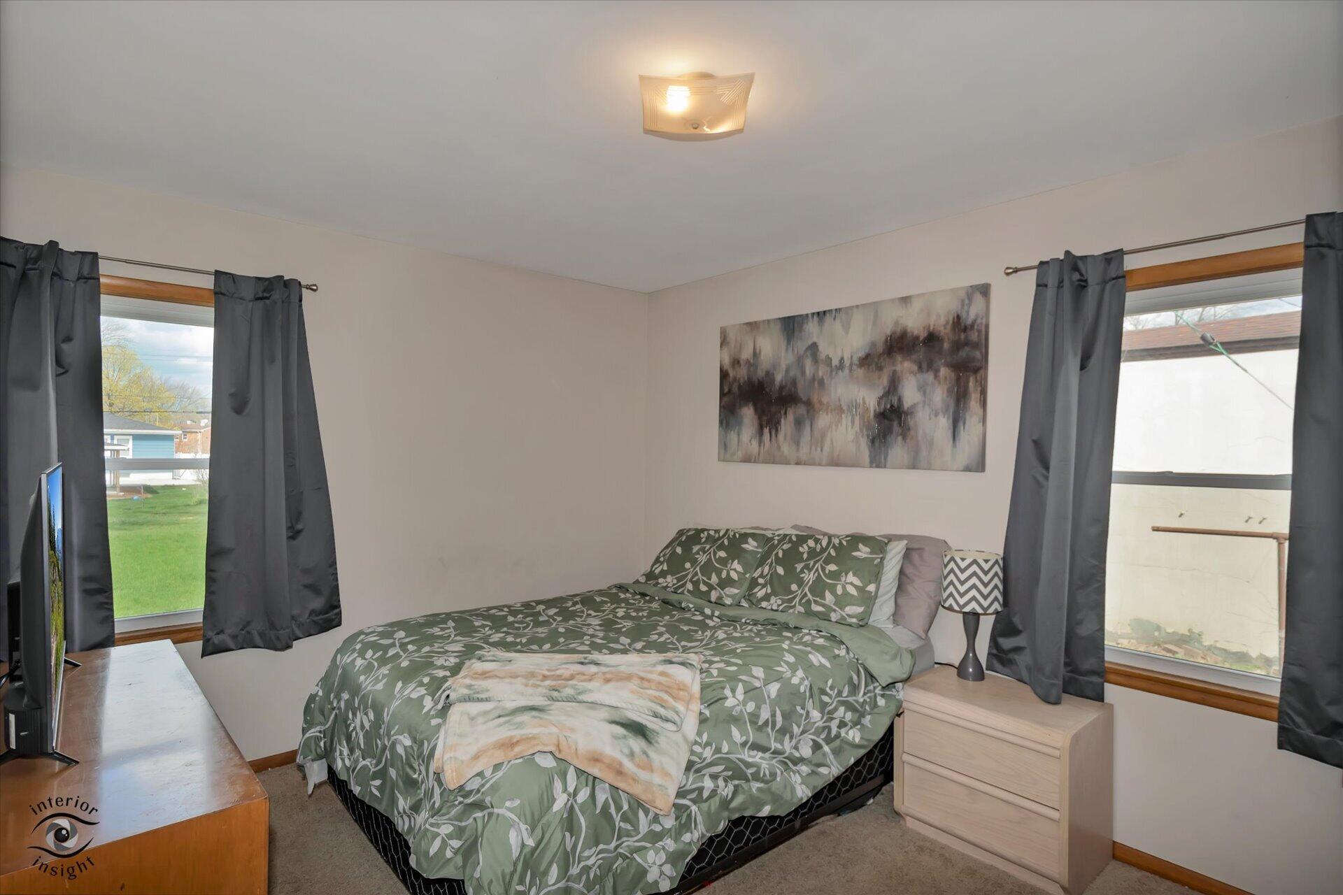 3341 Maple Drive Highland, IN 46322 - Photo 12 of 27 a bedroom with a bed and a window
