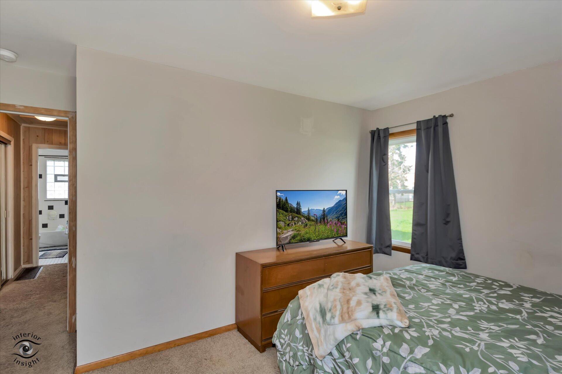 3341 Maple Drive Highland, IN 46322 - Photo 13 of 27 a bedroom with a bed and a flat screen tv