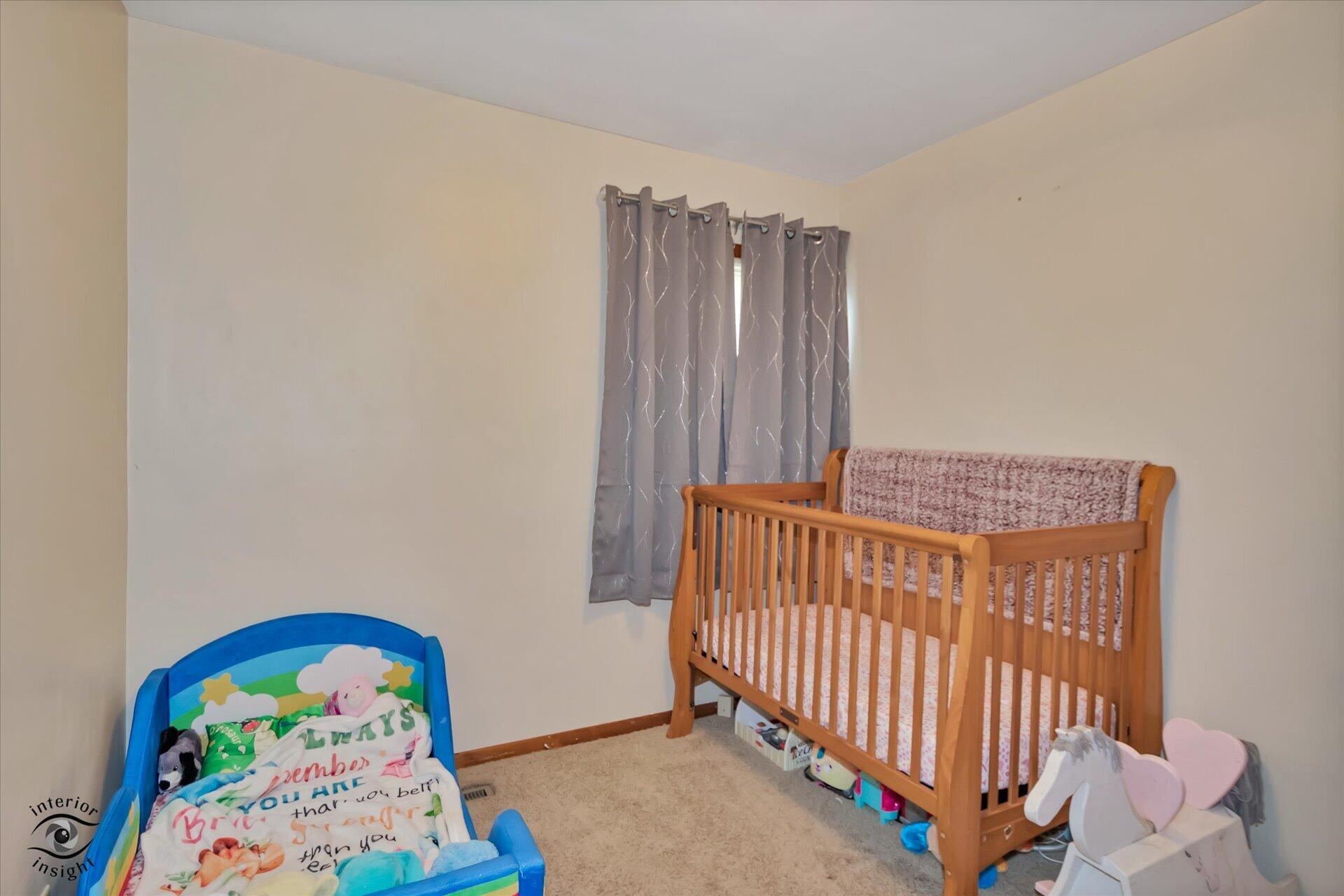 3341 Maple Drive Highland, IN 46322 - Photo 14 of 27 a view of a bedroom with baby crib and furniture