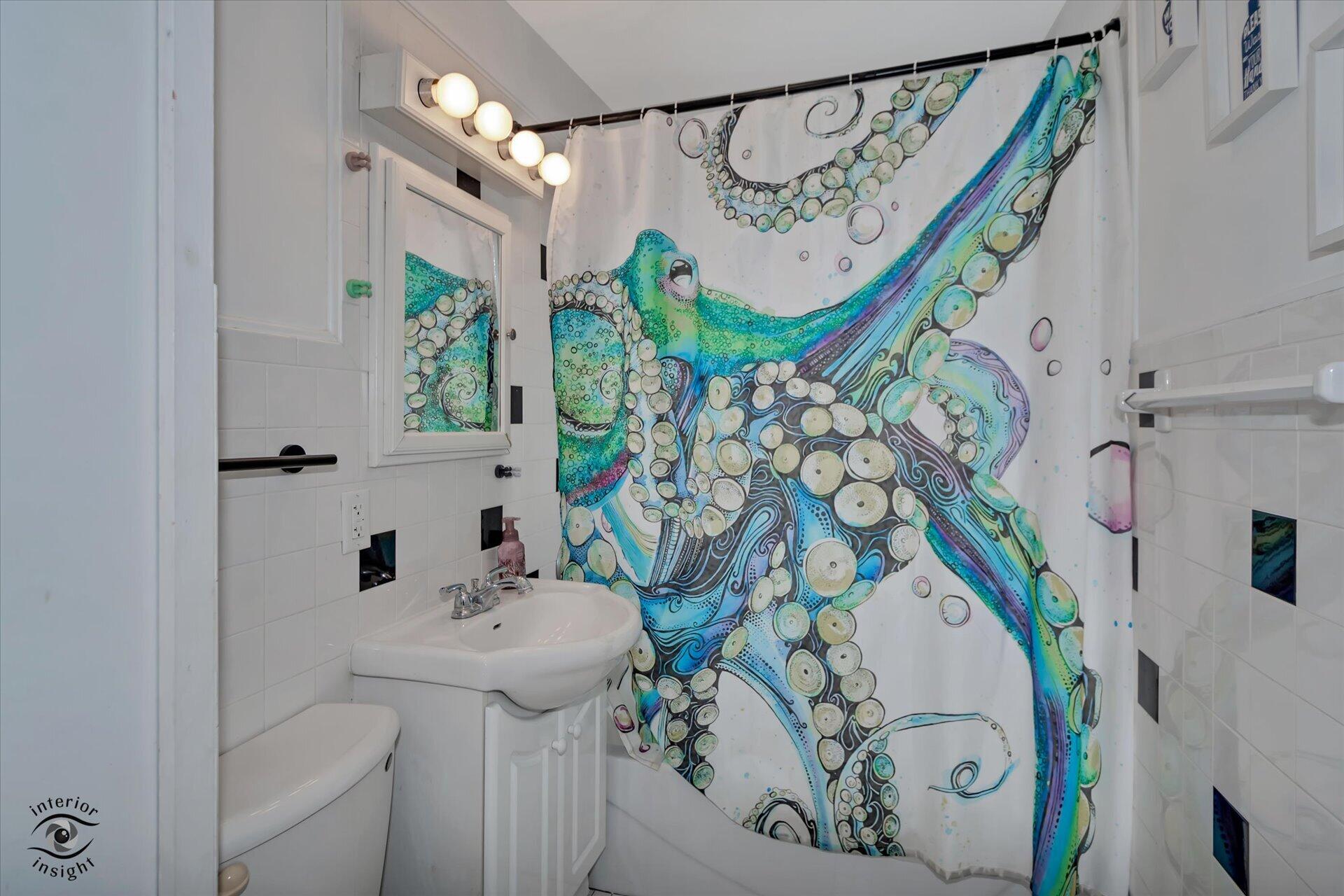 3341 Maple Drive Highland, IN 46322 - Photo 18 of 27 a bathroom with a sink and mirror with shower curtain