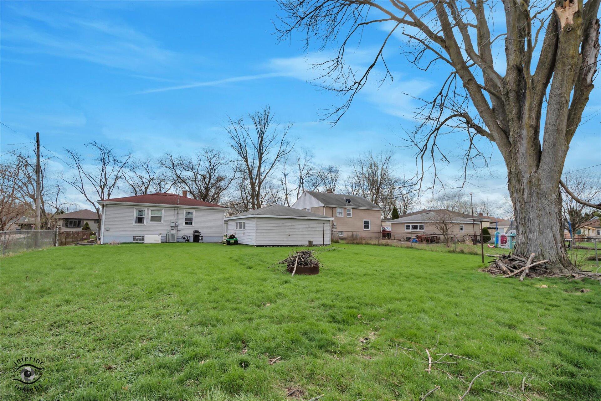 3341 Maple Drive Highland, IN 46322 - Photo 25 of 27 a garden with trees in front of it