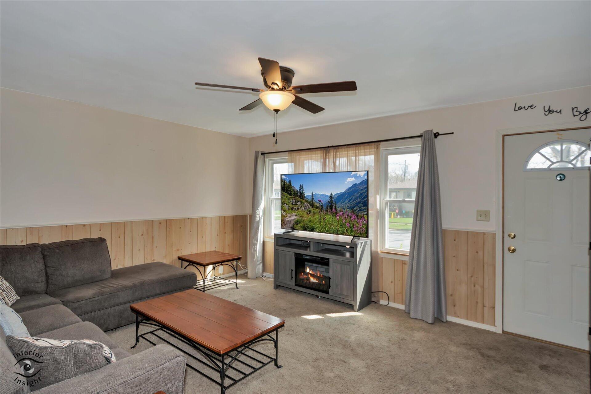 3341 Maple Drive Highland, IN 46322 - Photo 4 of 27 a living room with furniture a flat screen tv and a fireplace