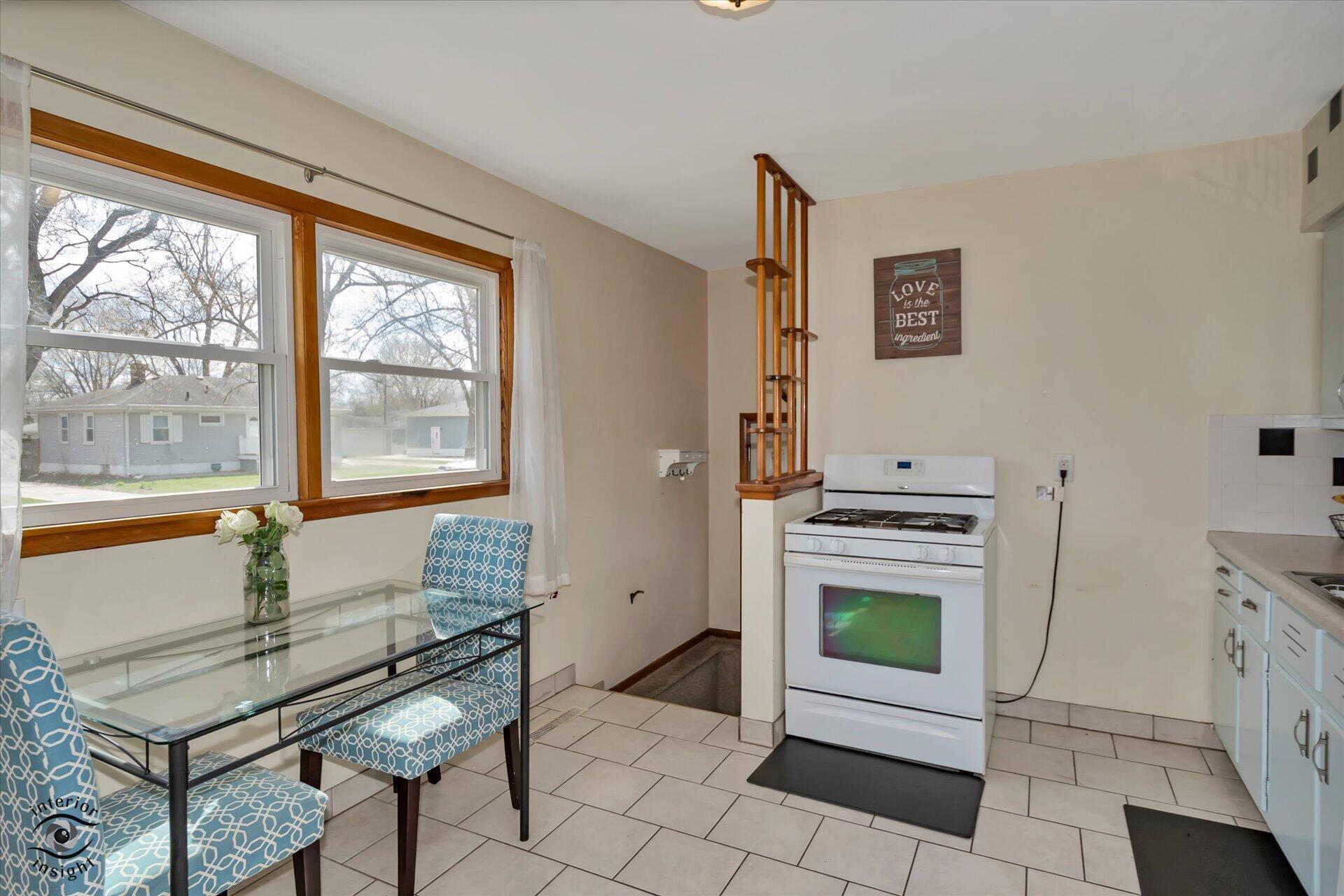 3341 Maple Drive Highland, IN 46322 - Photo 7 of 27 a living room with furniture a stove and a window