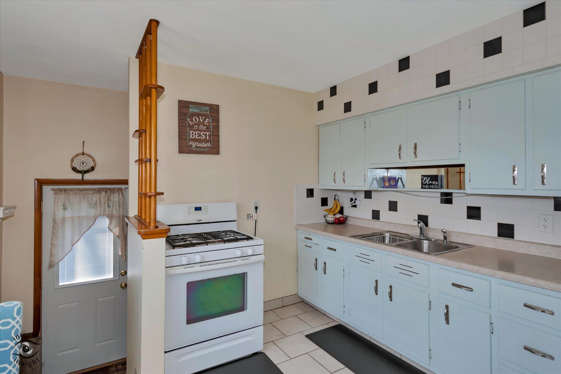 3341 Maple Drive Highland, IN 46322 - Photo 9 of 27 a kitchen with stainless steel appliances a stove a microwave and a refrigerator