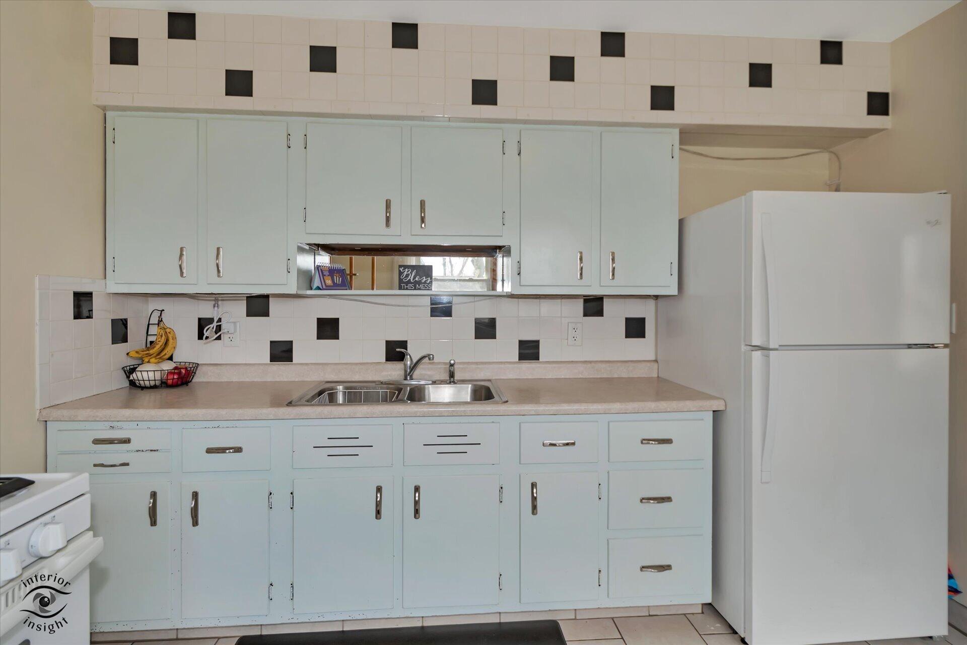 3341 Maple Drive Highland, IN 46322 - Photo 10 of 27 a kitchen with white cabinets and white appliances