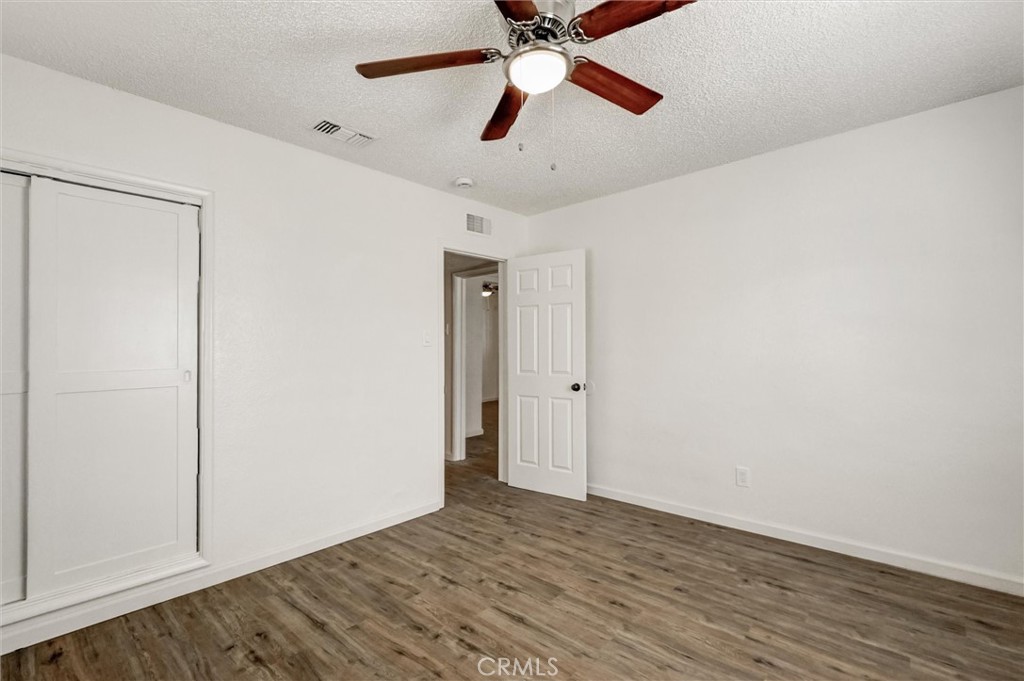 2734 Serrano Road North San Bernardino, CA 92405 - Photo 13 of 25 a view of empty room with wooden floor
