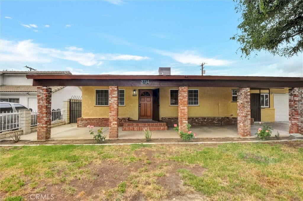 2734 Serrano Road North San Bernardino, CA 92405 - Photo 3 of 25 a front view of house with yard outdoor seating and barbeque oven