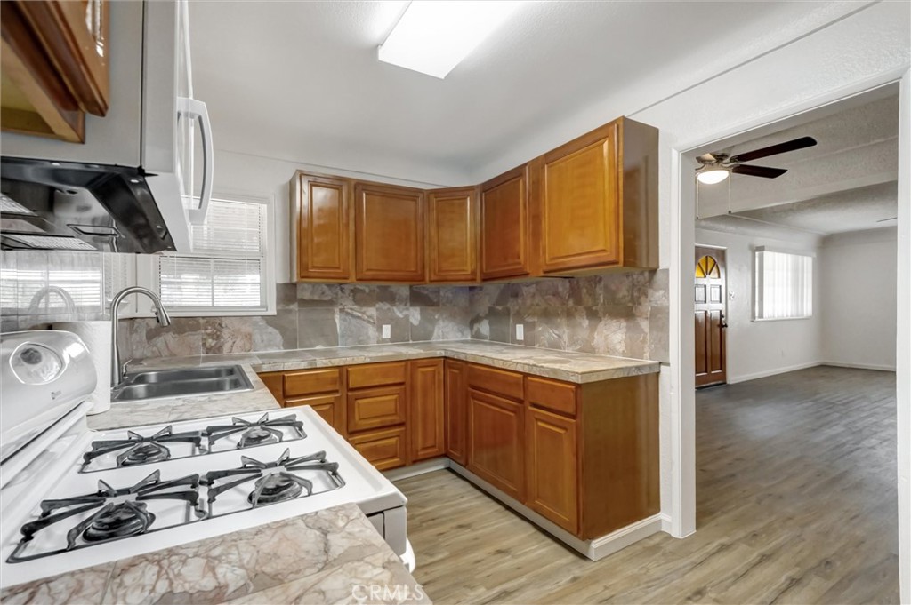 2734 Serrano Road North San Bernardino, CA 92405 - Photo 8 of 25 a kitchen with sink a stove and cabinets