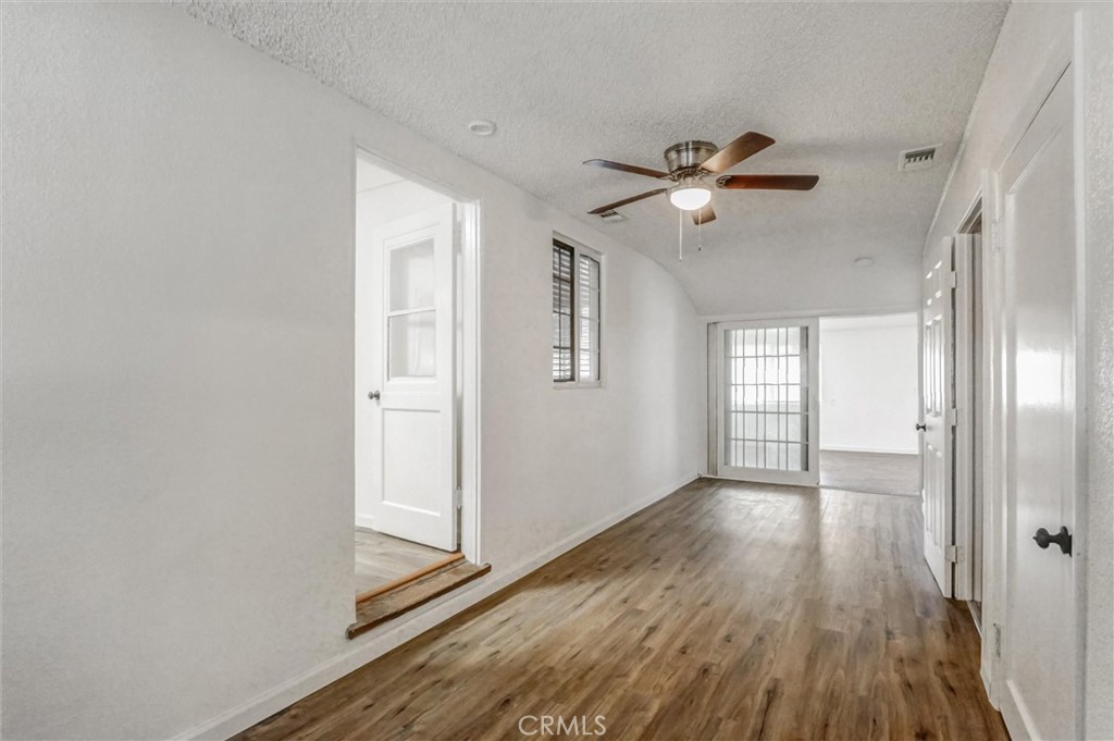 2734 Serrano Road North San Bernardino, CA 92405 - Photo 9 of 25 a view of empty room with wooden floor and fan