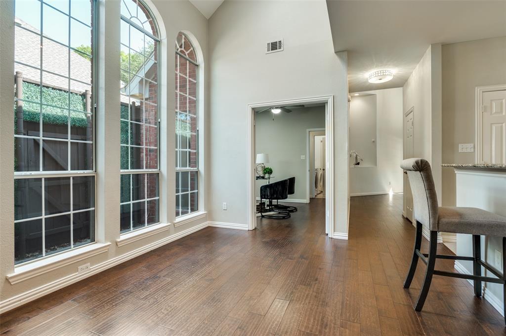 3840 Azure Lane Addison, TX 75001 - Photo 11 of 36 Dining area with dark wood-style flooring and a towering ceiling