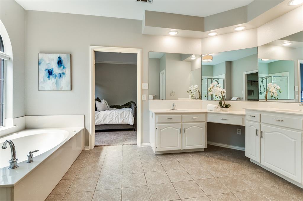 3840 Azure Lane Addison, TX 75001 - Photo 19 of 36 Ensuite bathroom featuring vanity, light tile patterned floors, a garden tub, recessed lighting, and a stall shower