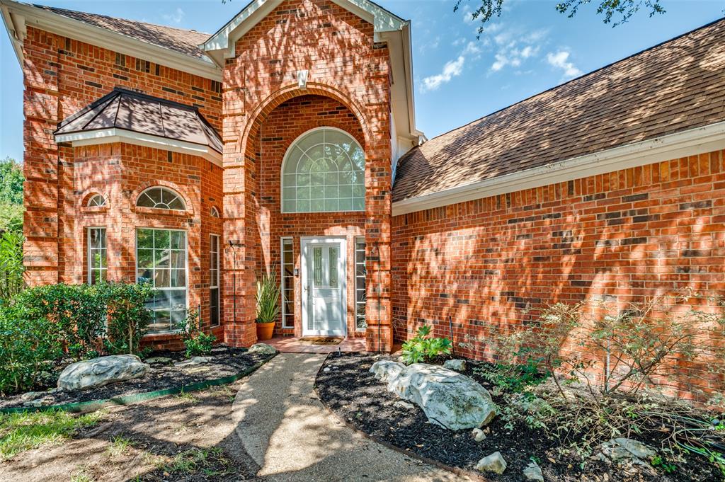 3840 Azure Lane Addison, TX 75001 - Photo 2 of 36 Doorway to property featuring brick siding and a shingled roof