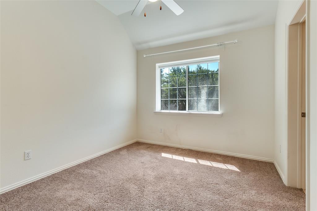3840 Azure Lane Addison, TX 75001 - Photo 21 of 36 Empty room featuring carpet, a ceiling fan, and vaulted ceiling
