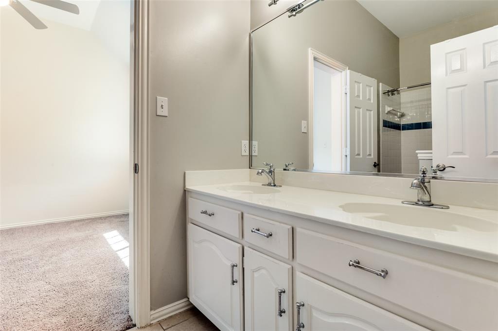 3840 Azure Lane Addison, TX 75001 - Photo 23 of 36 Full bath with double vanity, a shower, and light tile patterned floors