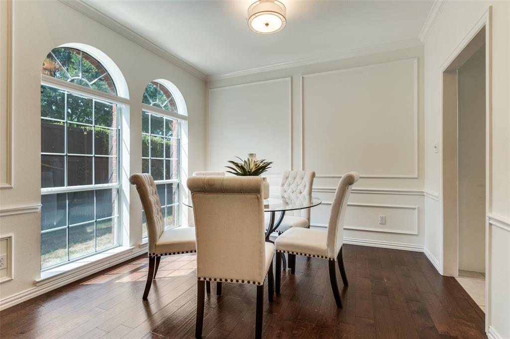 3840 Azure Lane Addison, TX 75001 - Photo 6 of 36 Dining room featuring a decorative wall, ornamental molding, and dark wood-style flooring