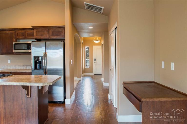 61723 Rigel Way Bend, OR 97702 - Photo 8 of 17 a view of a kitchen with stainless steel appliances granite countertop a refrigerator and a sink