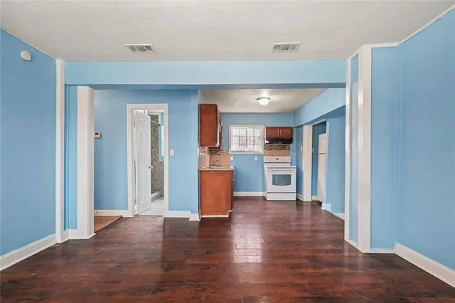 a view of a kitchen with wooden floor and a kitchen