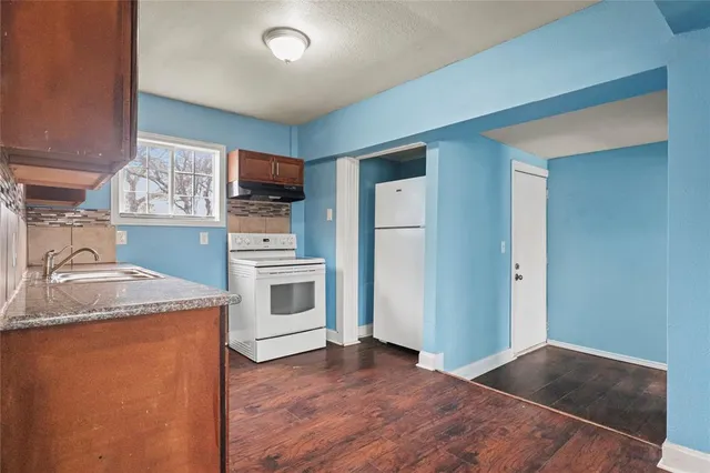 a kitchen with a stove top oven and cabinets