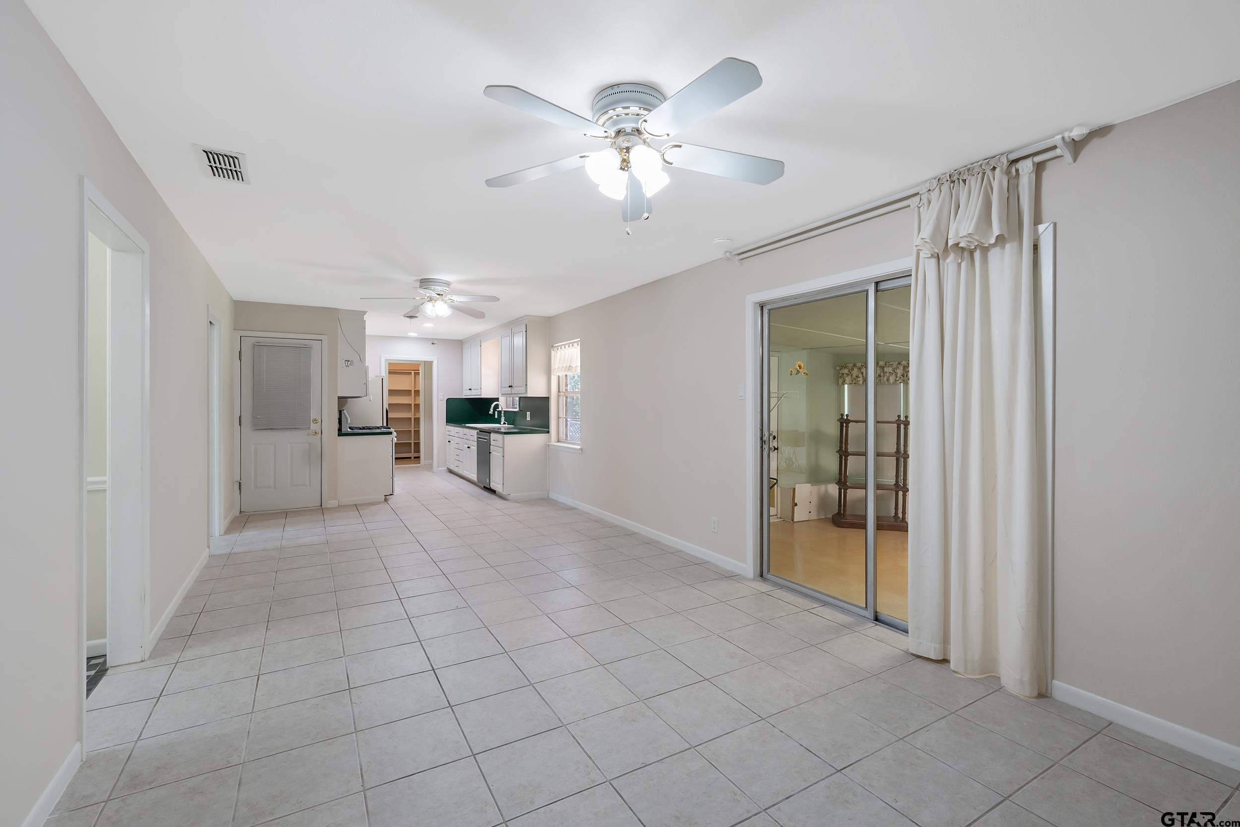 2026 Neeley Street Tyler, TX 75701 - Photo 12 of 26 a view of a livingroom with furniture and chandelier fan