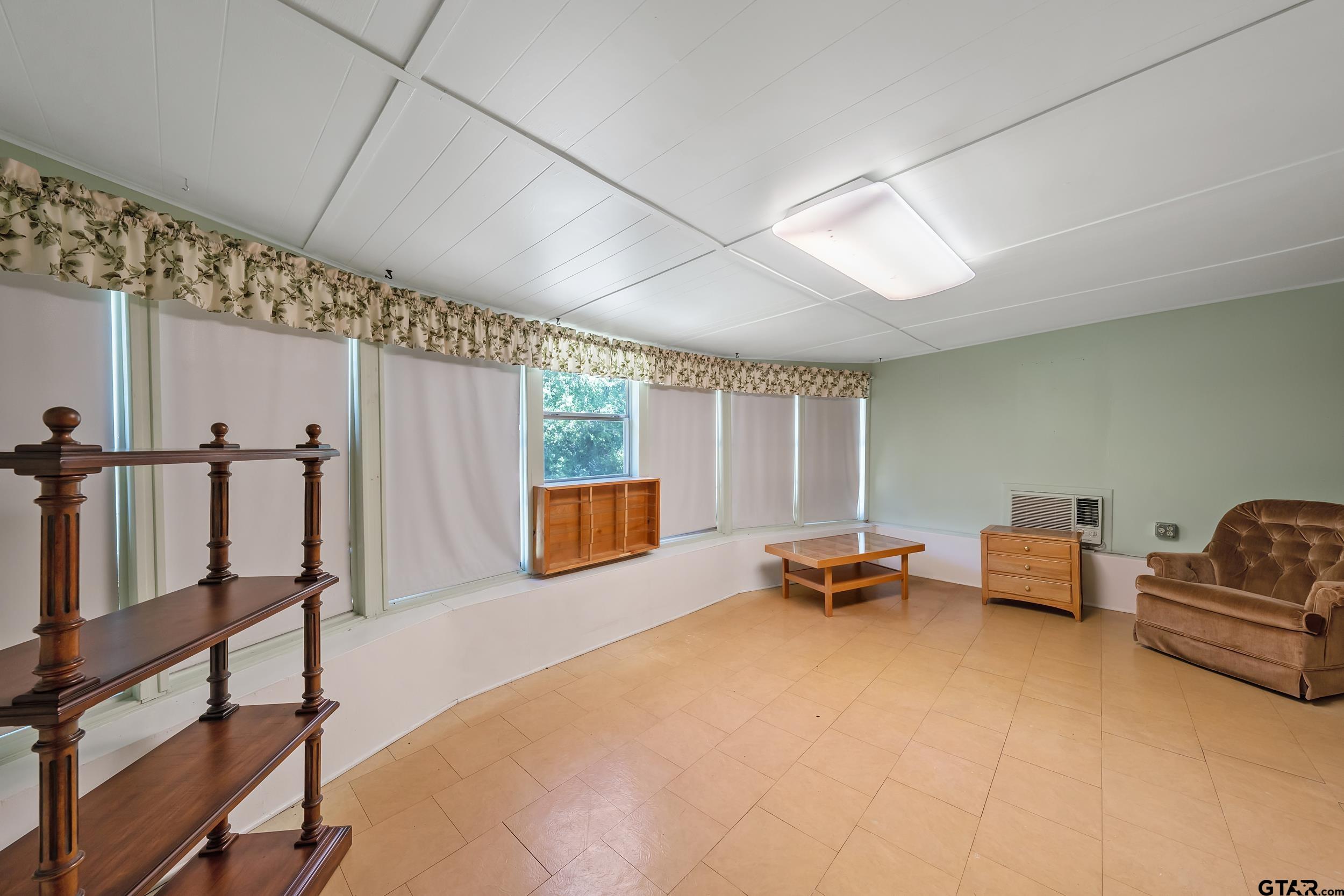 2026 Neeley Street Tyler, TX 75701 - Photo 13 of 26 a bedroom with furniture and wooden floor
