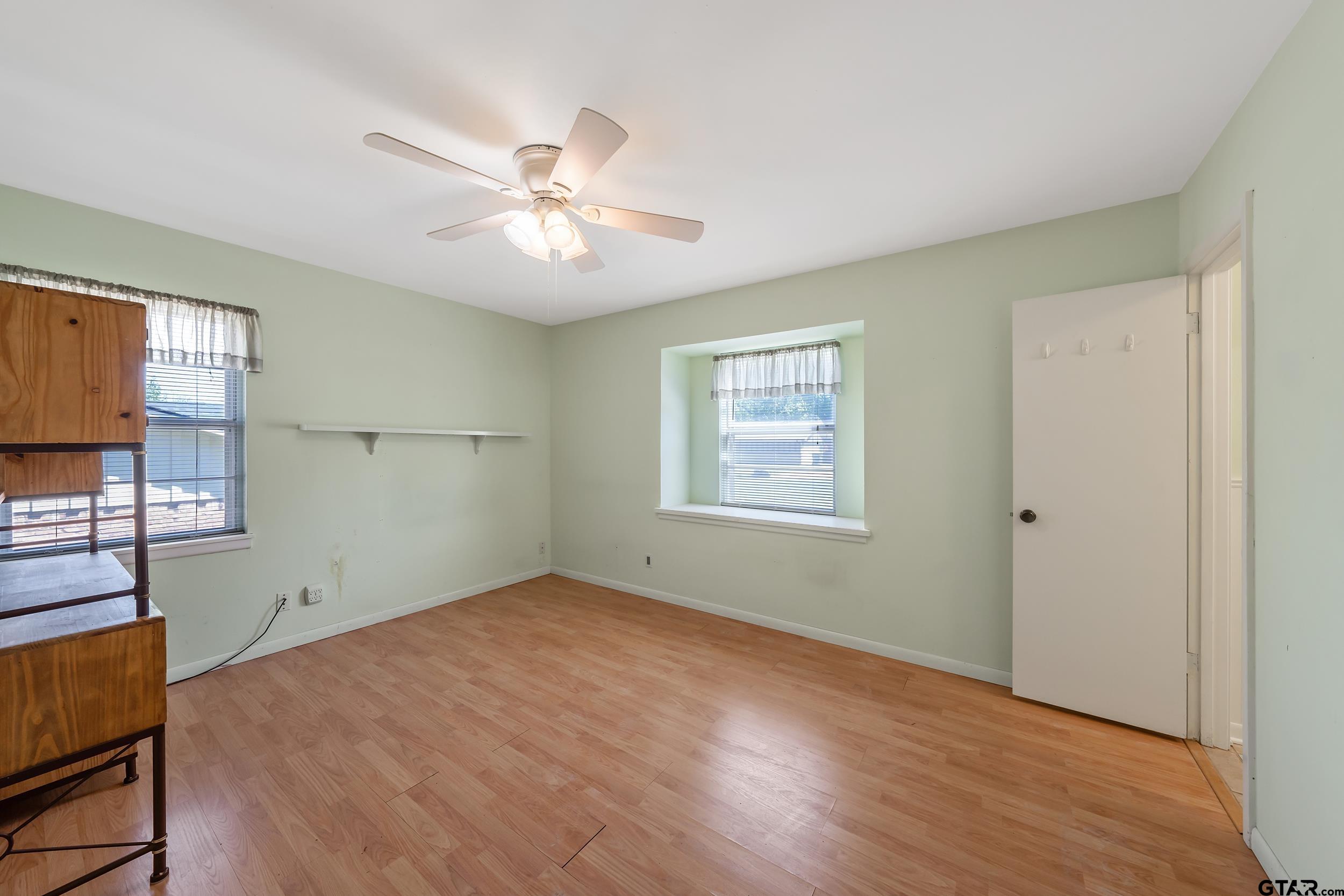 2026 Neeley Street Tyler, TX 75701 - Photo 19 of 26 a view of empty room with wooden floor and fan